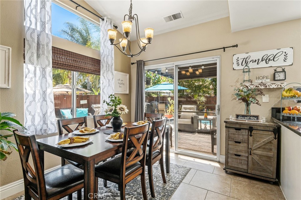 7615 Canberra Way Riverside, CA 92508 - Photo 7 of 37 a view of a dining room with furniture large windows and wooden floor