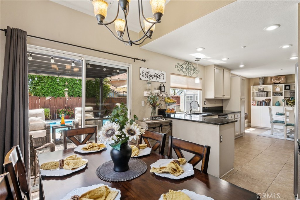 7615 Canberra Way Riverside, CA 92508 - Photo 8 of 37 a kitchen with a table and chairs in it