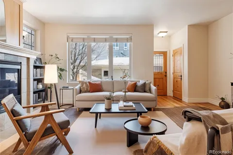 a living room with fireplace furniture and a floor to ceiling window