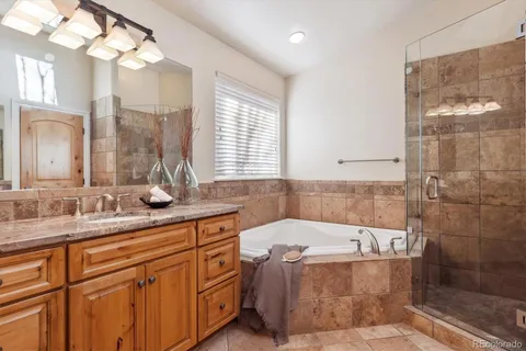 a bathroom with a tub sink and mirror