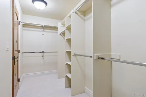 a view of walk in closet with empty racks