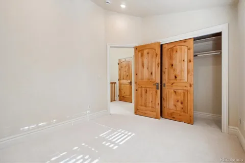 a bathroom with a granite countertop sink a toilet a mirror a bathtub and shower