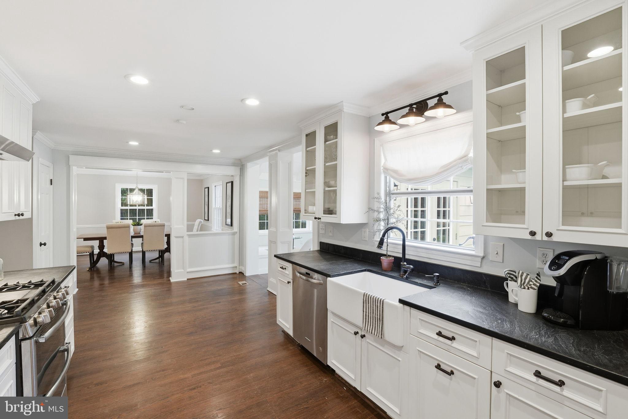 8436 Burning Tree Road Bethesda, MD 20817 - Photo 12 of 34 a kitchen with granite countertop a sink and cabinets