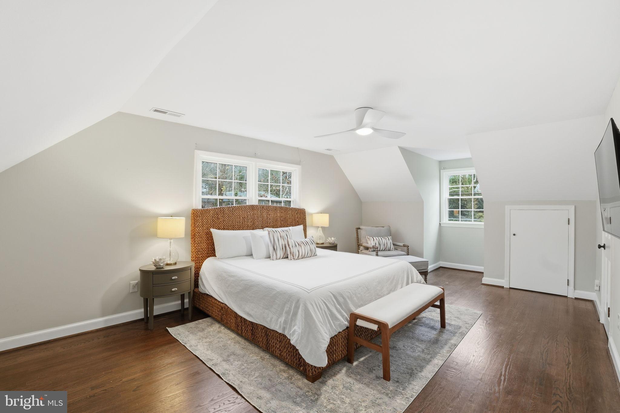 8436 Burning Tree Road Bethesda, MD 20817 - Photo 17 of 34 a bedroom with a bed and a lamp