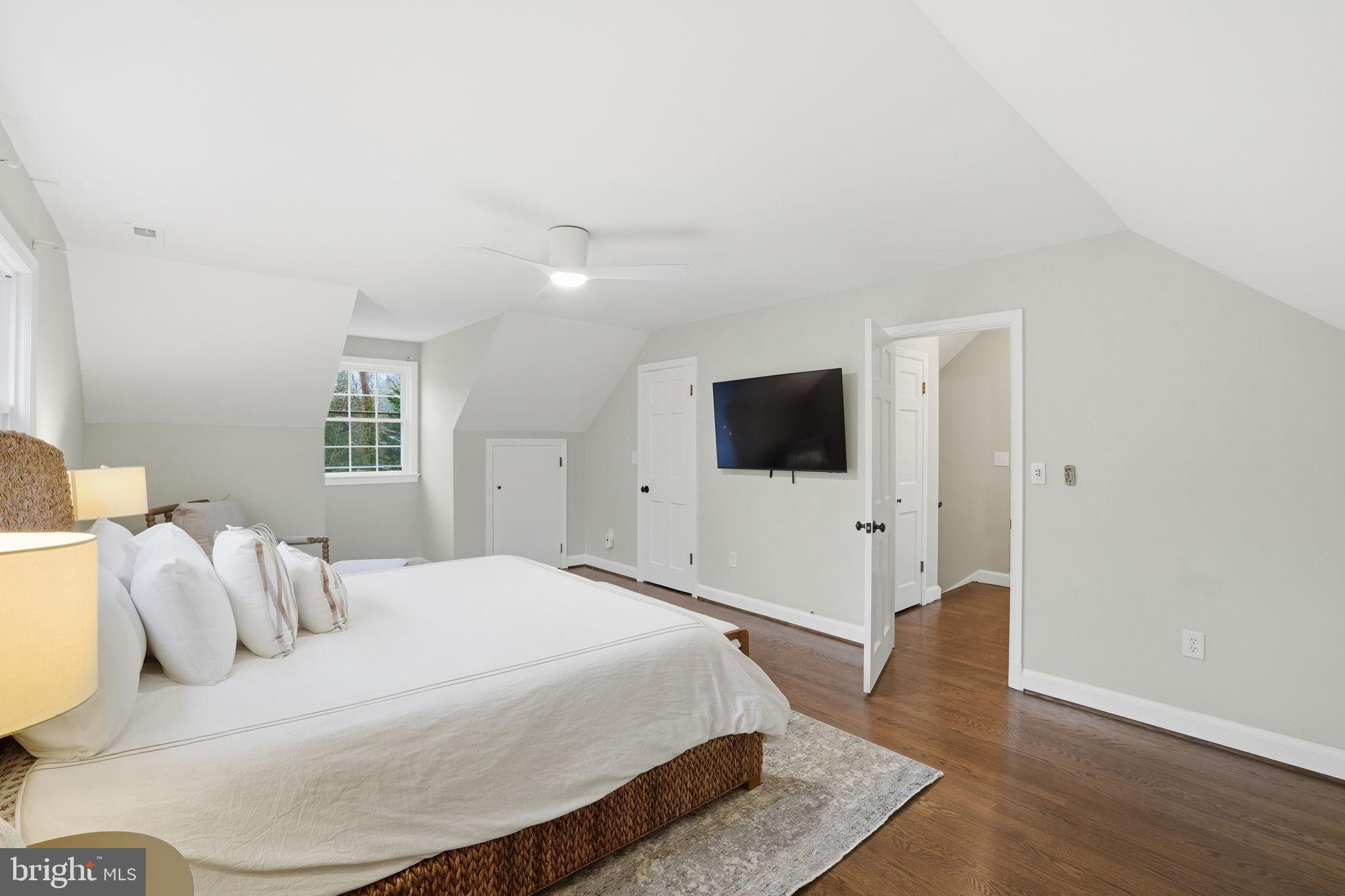 8436 Burning Tree Road Bethesda, MD 20817 - Photo 18 of 34 a bedroom with a bed and a flat screen tv