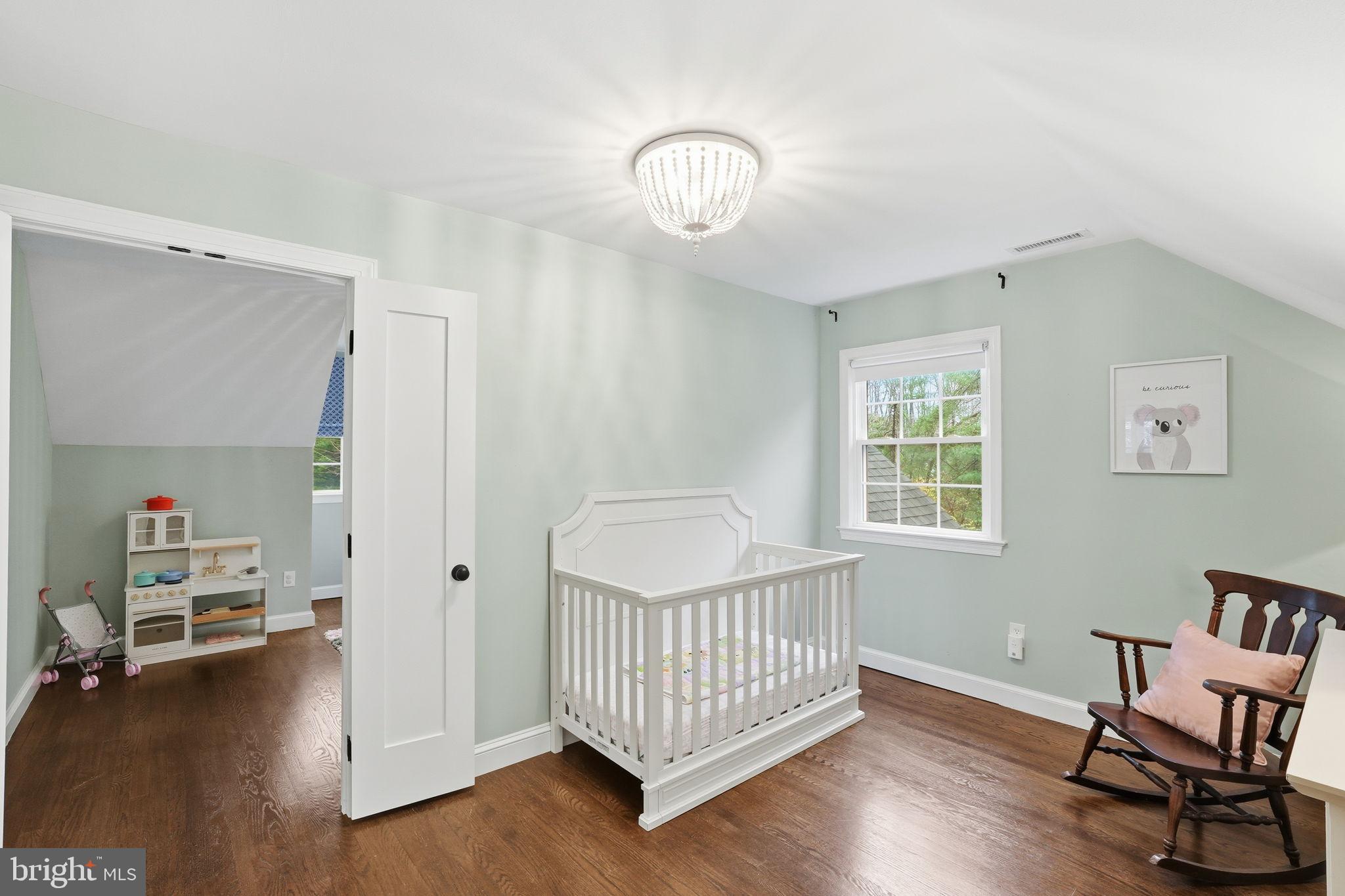 8436 Burning Tree Road Bethesda, MD 20817 - Photo 21 of 34 a view of a room with wooden floor and windows