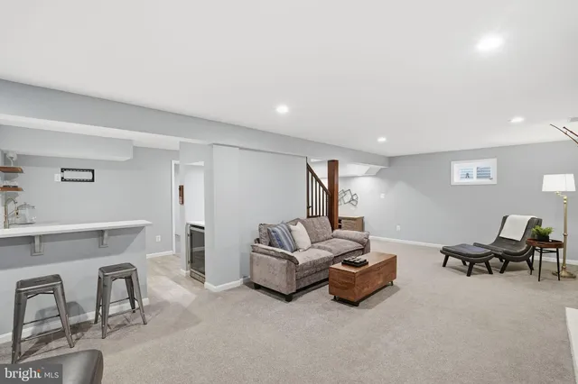 a living room with furniture and a lamp