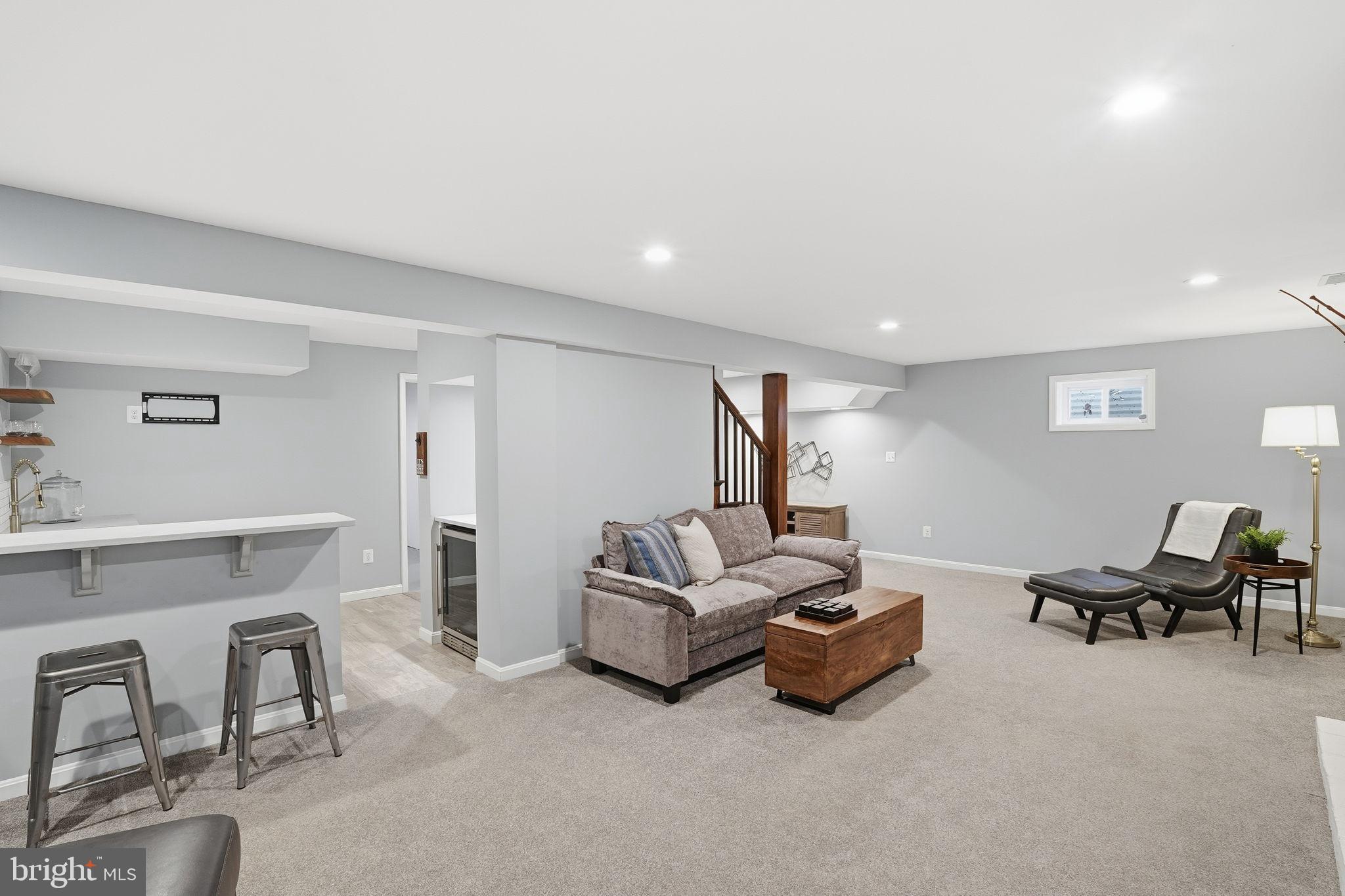 8436 Burning Tree Road Bethesda, MD 20817 - Photo 25 of 34 a living room with furniture and a lamp