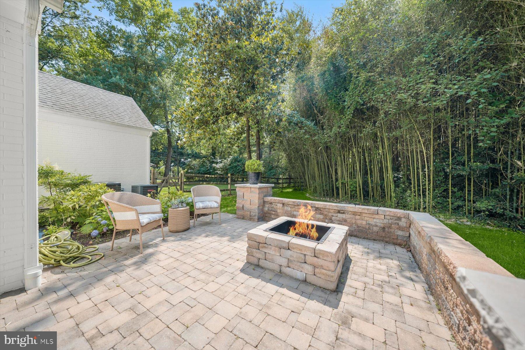 8436 Burning Tree Road Bethesda, MD 20817 - Photo 29 of 34 a view of backyard with a table and chairs fire pit and large trees