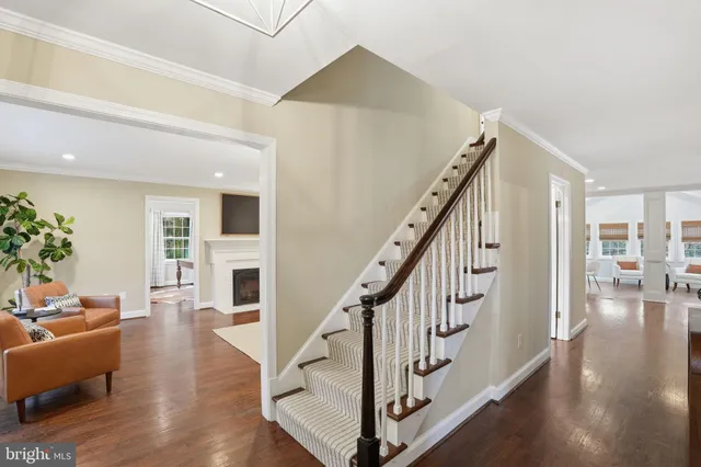 a view of entryway and hall with wooden floor