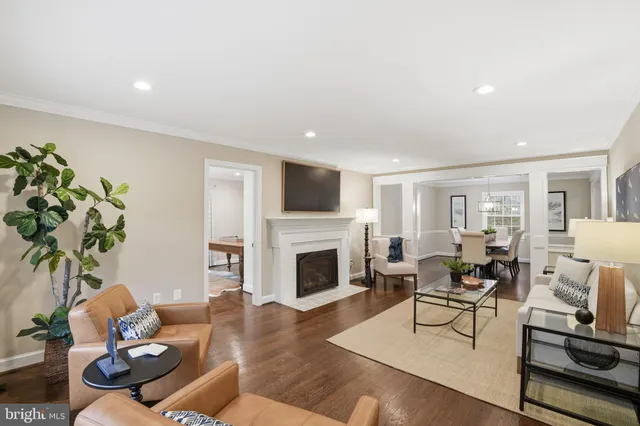 a living room with furniture fireplace and wooden floor