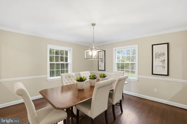 a dining room with furniture a window and wooden floor