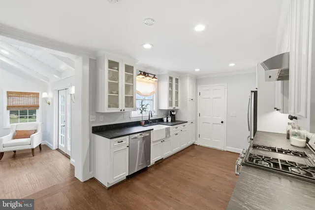 a kitchen with stainless steel appliances granite countertop a stove and a sink