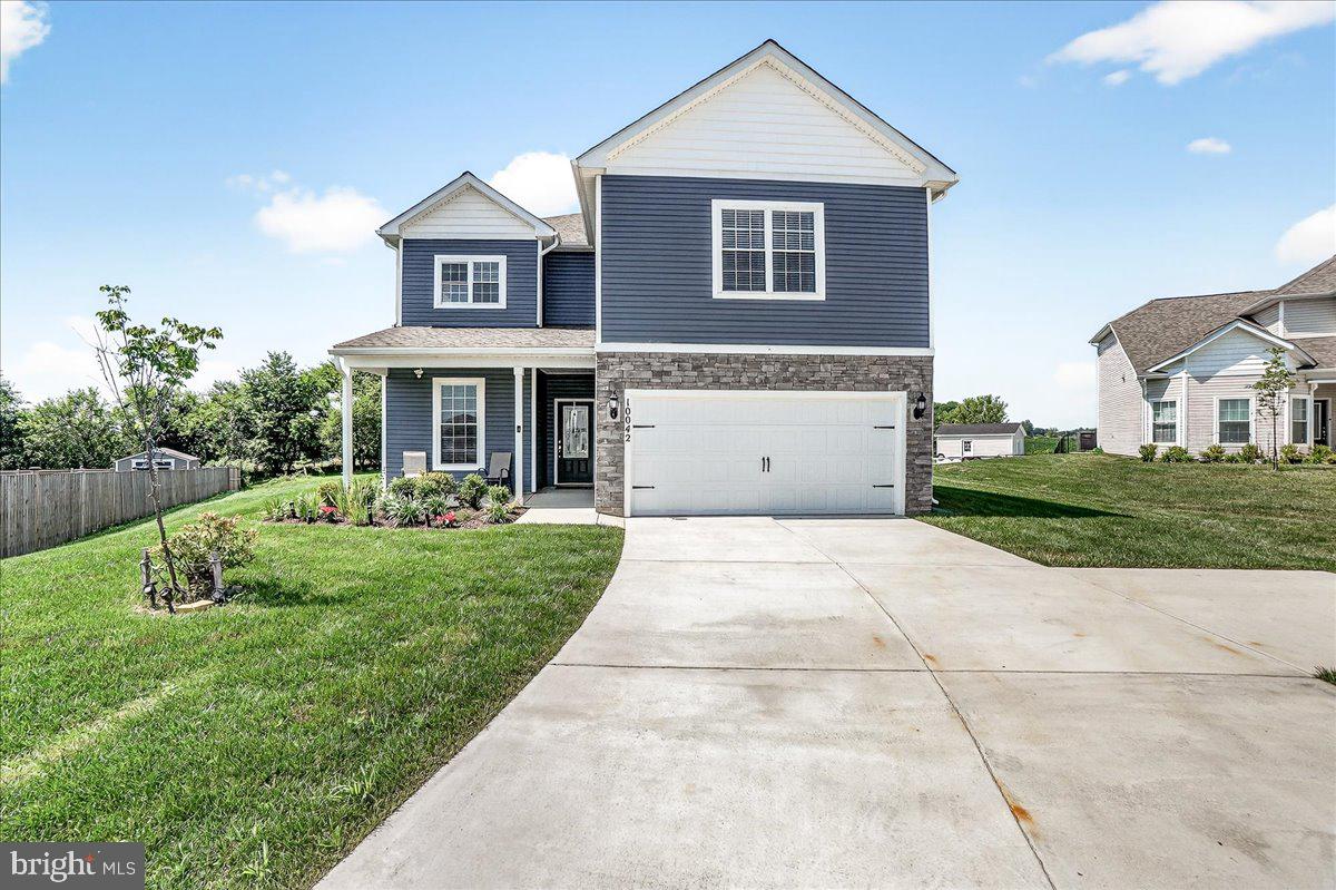 a view of a house with a yard and potted plants