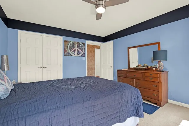 a bedroom with a bed and a dresser in it