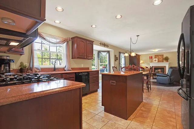 a kitchen with large cabinets a sink a window and appliances
