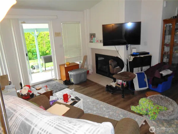 a living room with furniture a fireplace and a flat screen tv