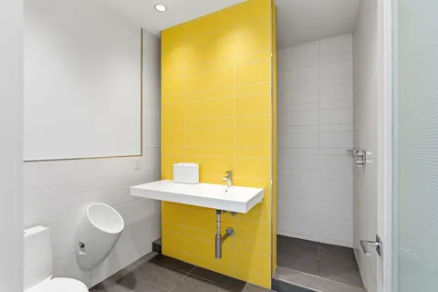 a bathroom with a sink mirror and a toilet