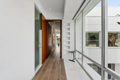 a view of a hallway with wooden floor and staircase