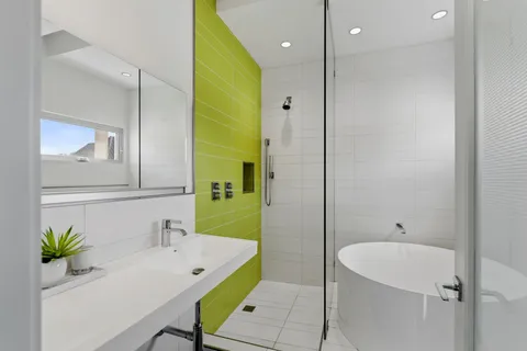 a bathroom with a bathtub a sink and a mirror