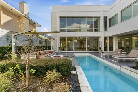 a view of a house with a large window and sitting area