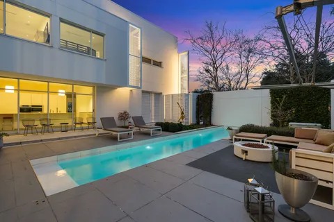 a view of a patio with a table chairs and a fire pit