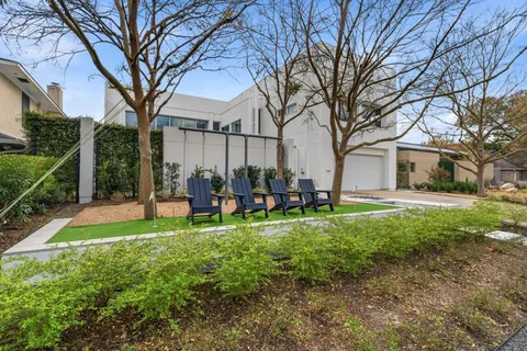 a backyard of a house with table and chairs