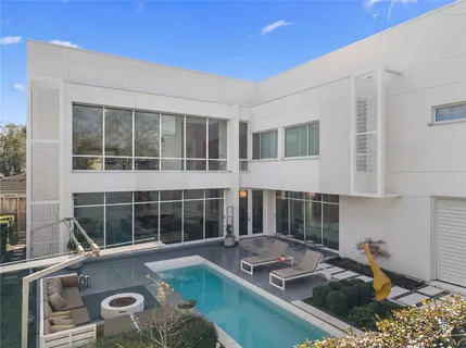 a view of a house with swimming pool and sitting area