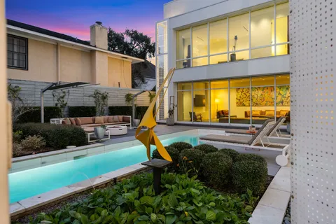 a view of a house with a backyard porch and sitting area