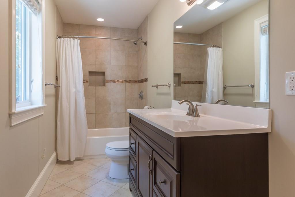 45 Village Circle Newton, MA 02459 - Photo 15 of 18 a bathroom with a sink toilet double vanity and shower
