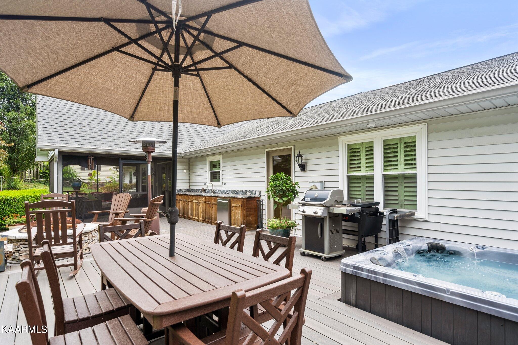 1309 Ridgeway Circle Athens, TN 37303 - Photo 33 of 48 a view of a roof deck with table and chairs under an umbrella