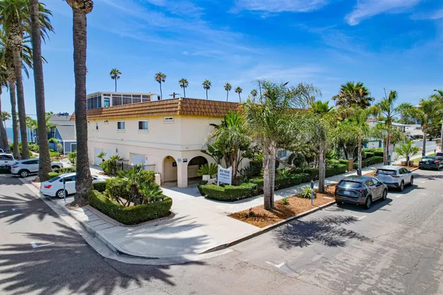 a view of a street with cars parked