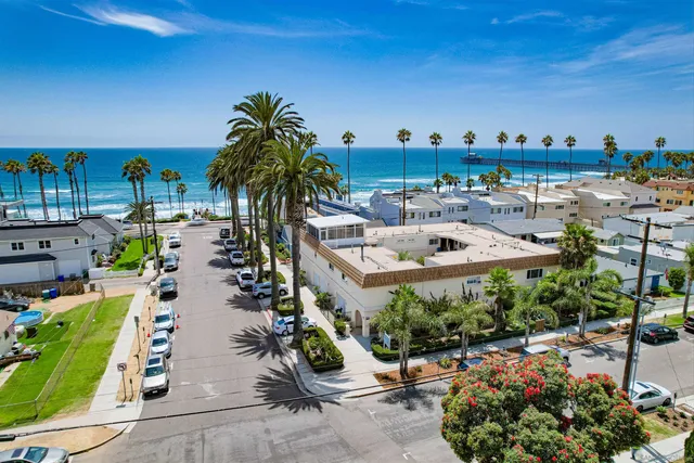 a view of a swimming pool with outdoor seating and plants
