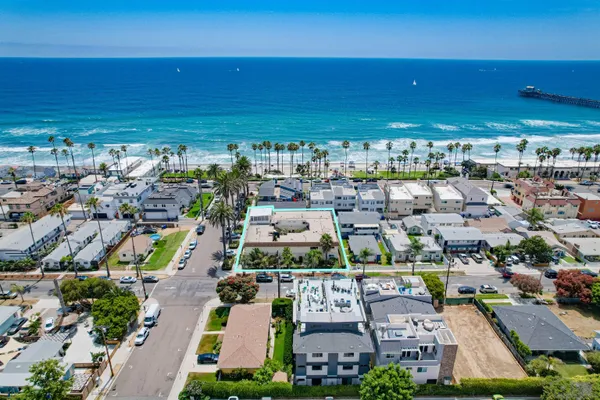 an aerial view of multiple houses with outdoor space