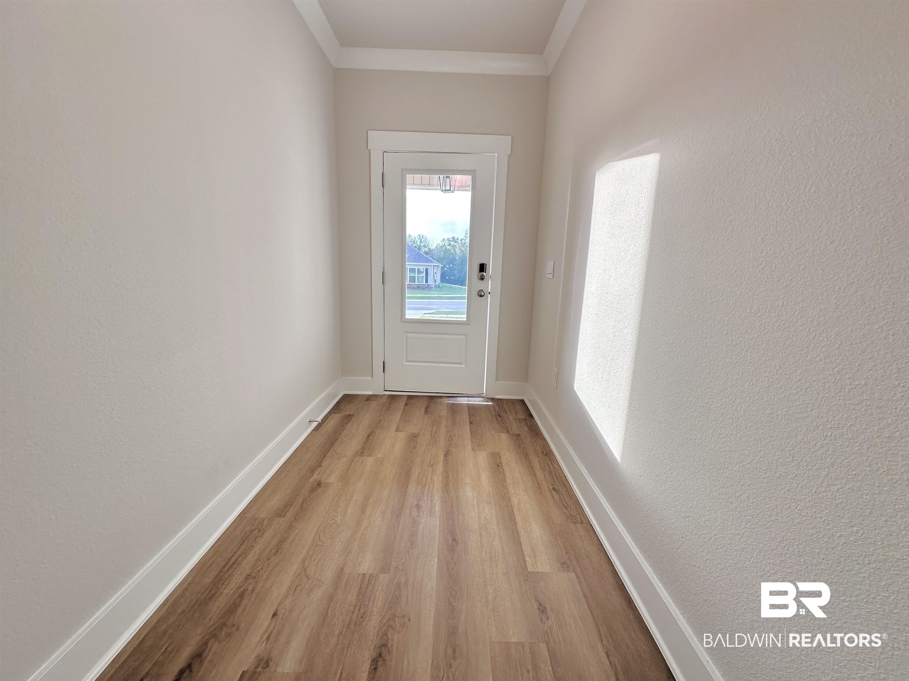 342 Barndling Street Fairhope, AL 36532 - Photo 8 of 50 Entryway with light wood-type flooring and crown molding