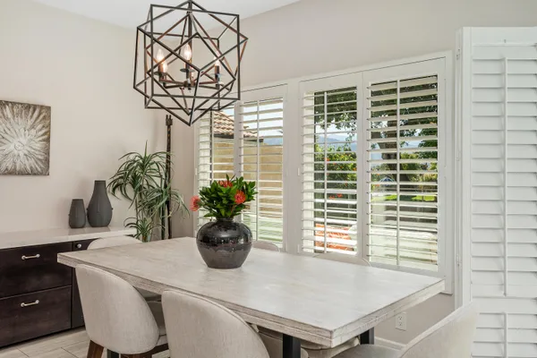 a view of a dining room with furniture and a potted plant