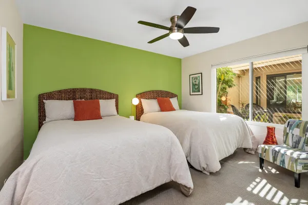 a bedroom with a bed and a large window