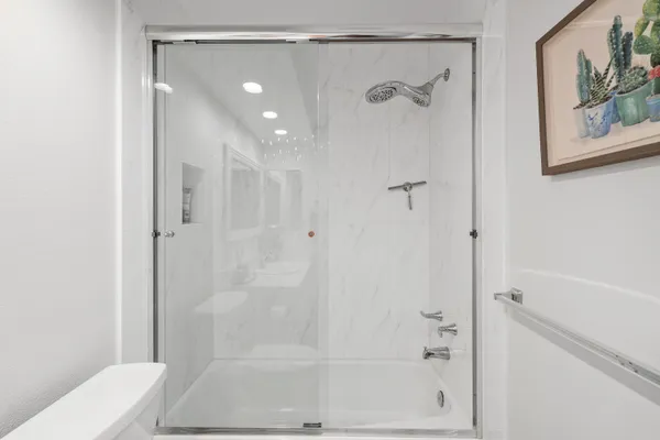a bathroom with a glass shower door