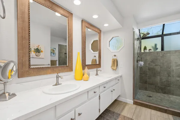 a bathroom with a granite countertop sink and a mirror