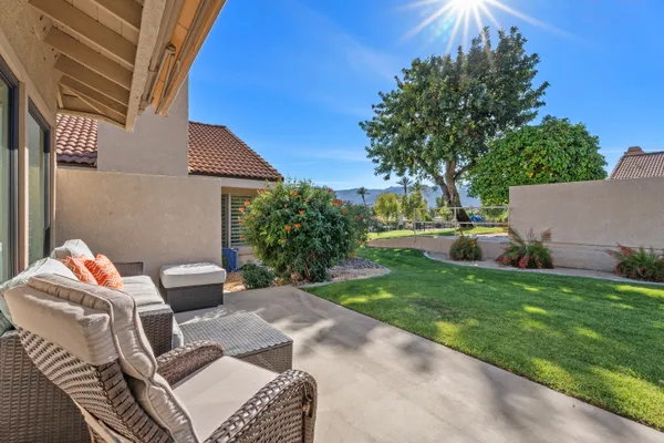 a view of backyard of house with seating space