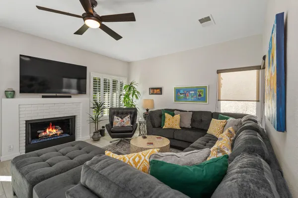a living room with furniture a flat screen tv and a fireplace