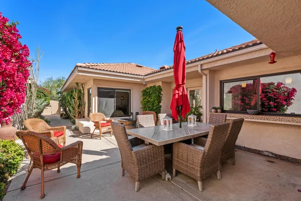 a view of a house with patio furniture and a potted plants
