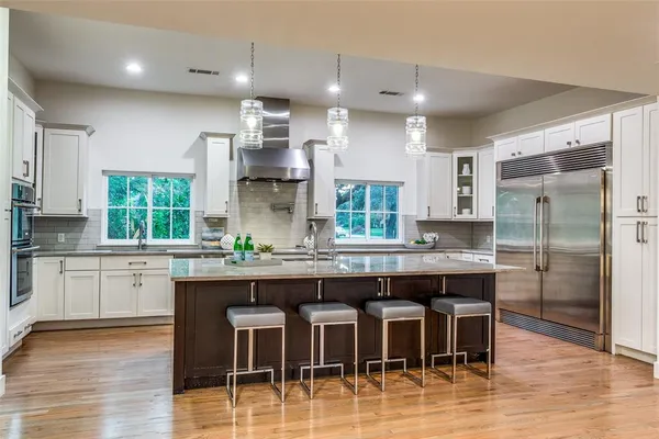 a large kitchen with a table and chairs in it