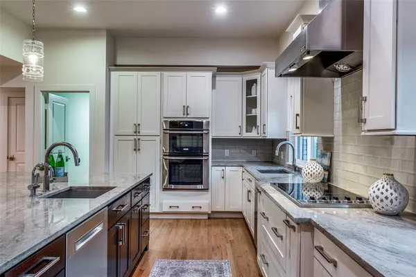 a kitchen with a sink a stove and cabinets