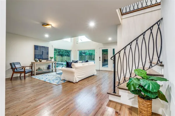 a living room with furniture fireplace and wooden floor