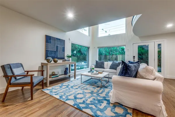 a living room with furniture a fireplace and a table
