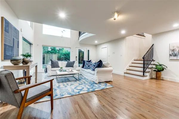 a living room with furniture and wooden floor