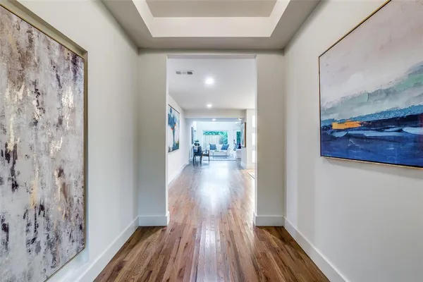 a view of a hallway view with wooden floor and staircase