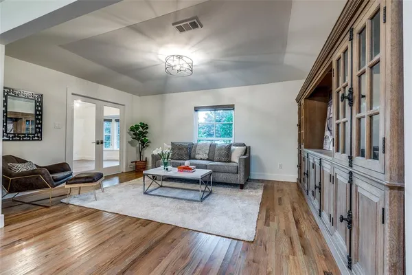 a living room with furniture and a wooden floor