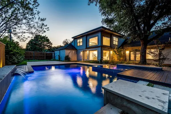 a view of swimming pool with lounge chair and dinning table